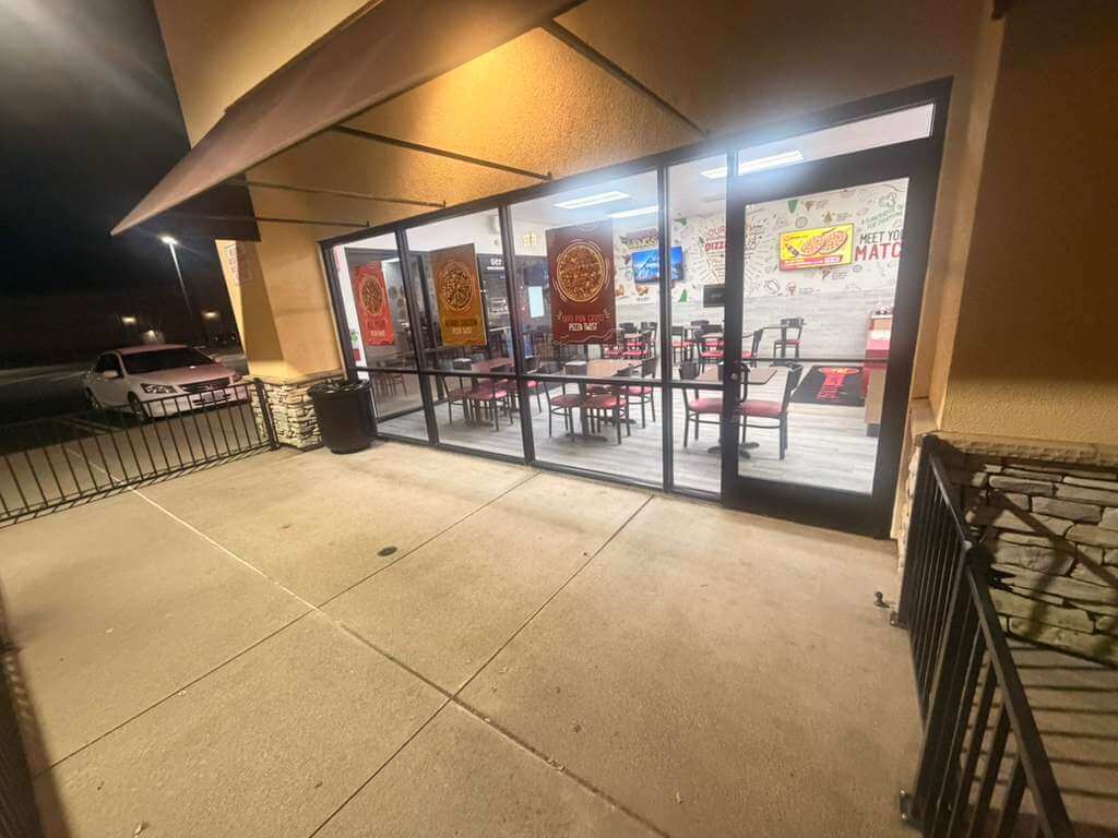 Exterior of a pizza restaurant in El Dorado Hills at night. "Meet Your Match" sign visible.